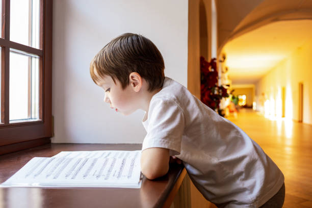 istock 6 year old boy learns to read music at music school 1761329508