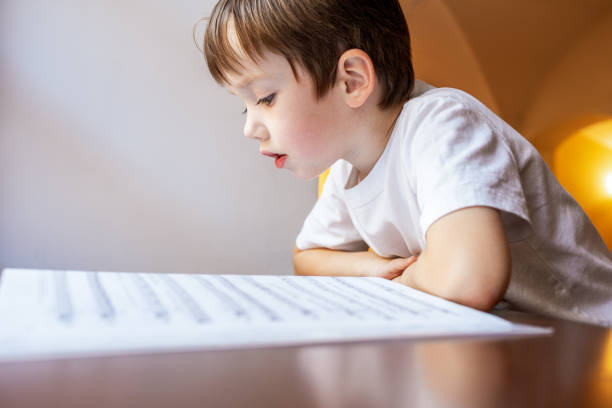 6 year old boy learns to read music at music school