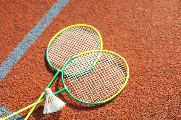 istock Badminton rackets and feather shuttlecock on the court 1761331691