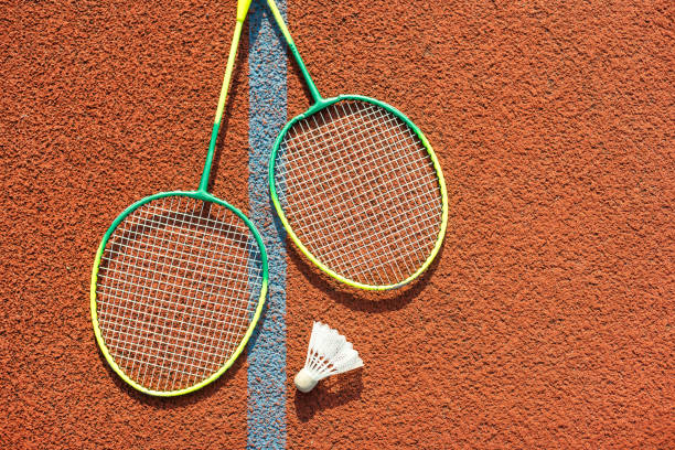 istock Badminton rackets and feather shuttlecock on the court 1761332716