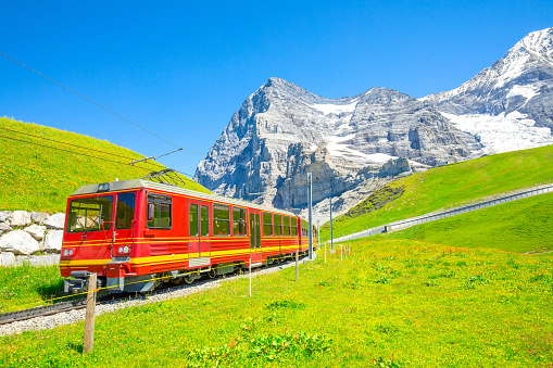 Scenic view of Swiss Alps and Jungfraubahn red train, Switzerland travel photo