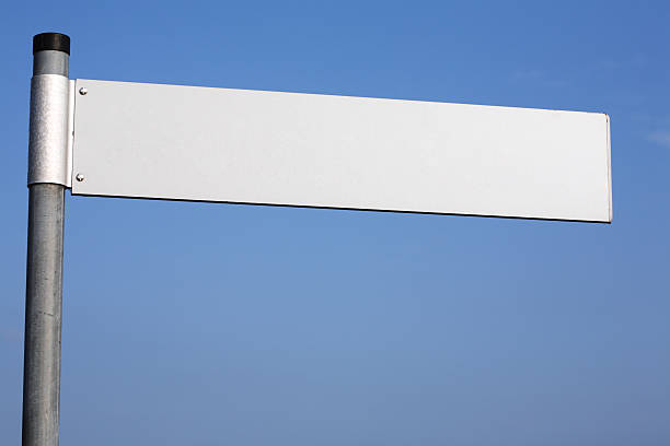 Looking up at the steel tree under the blue sky and white clouds