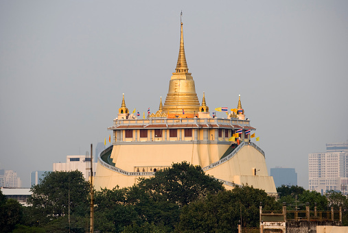 Golden Mount temple (Wat Saket Ratcha Wora Maha Wihan or simply known as Wat Saket) across the rooftops in Bangkok Thailand. 