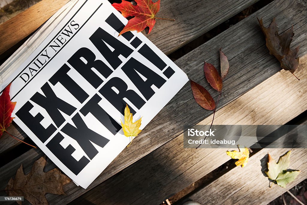 EXTRA! Newspaper on Wooden Steps with Autumn Leaves "Color photo of a daily newspaper announcing ""EXTRA! EXTRA!"" with autumn leaves on the steps of a wooden deck." Advertisement Stock Photo