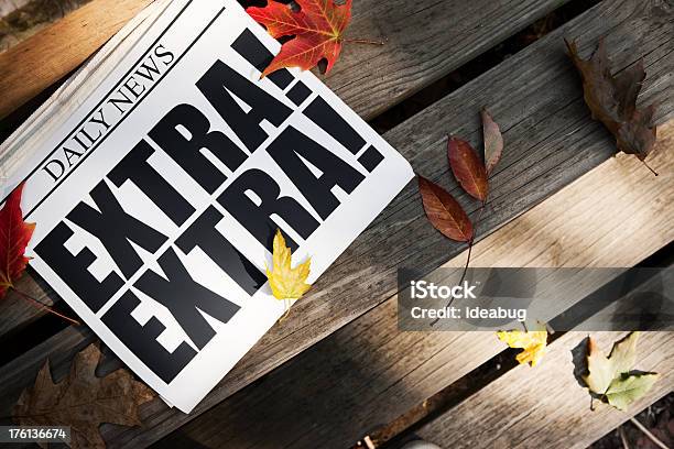 Extra Newspaper On Wooden Steps With Autumn Leaves Stock Photo - Download Image Now