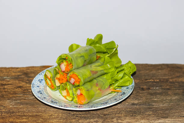 Salad roll put on the dish with white background. Put on the wooden ,The menu for healthy care.