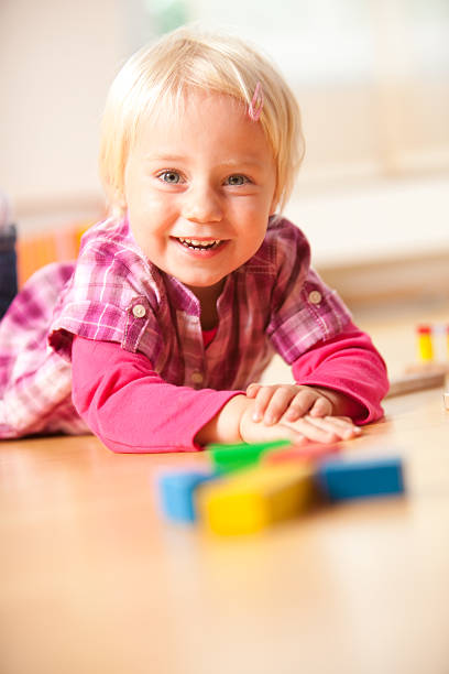 istock happy girl is playing with blocks 176139352