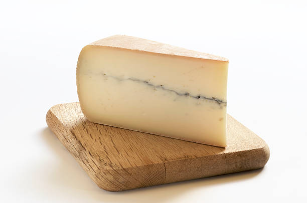 Morbier Cheese on Cutting Board stock photo