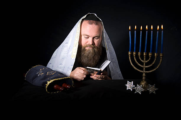 Rabbi Reads From the Siddur During Prayers stock photo
