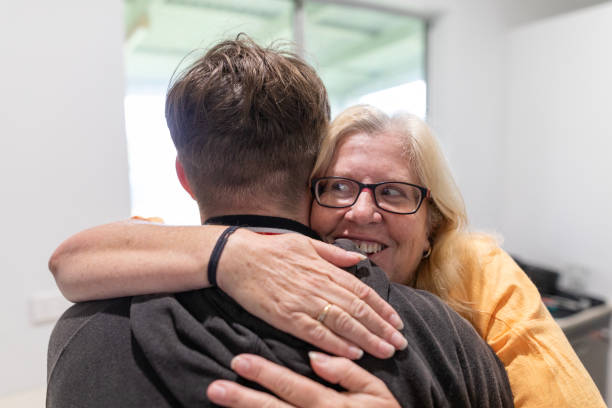 istock Mother and teenage son hugging 1761421623