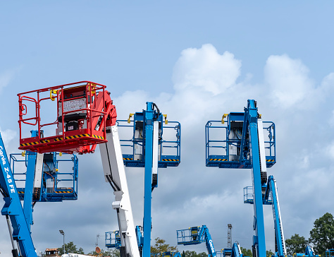 Group of aerial work platforms for construction and material handling. Close-up to the basket for moving people