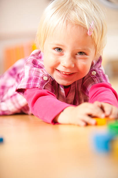 istock happy girl is playing with blocks 176145336