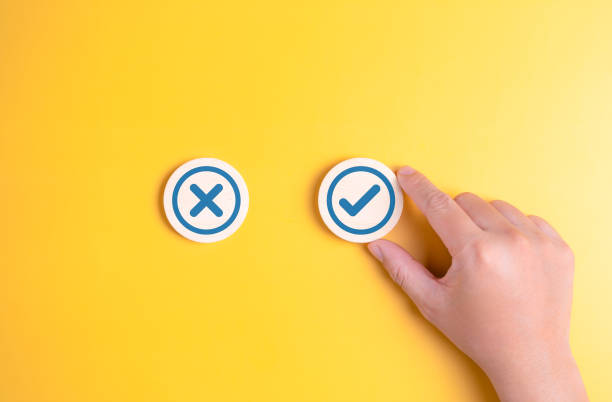 istock Hand choosing check mark sign, TRUE and FALSE symbols on wooden blocks. Accept and reject for evaluation, Yes and no option, Positive or negative decision, Making a choice of approval or rejection. 1761460085