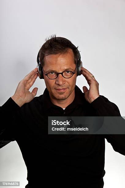 Portrait Of Young Man With Glasses Listening Music Headphones Stock Photo - Download Image Now