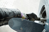 hand in glove filling a tank