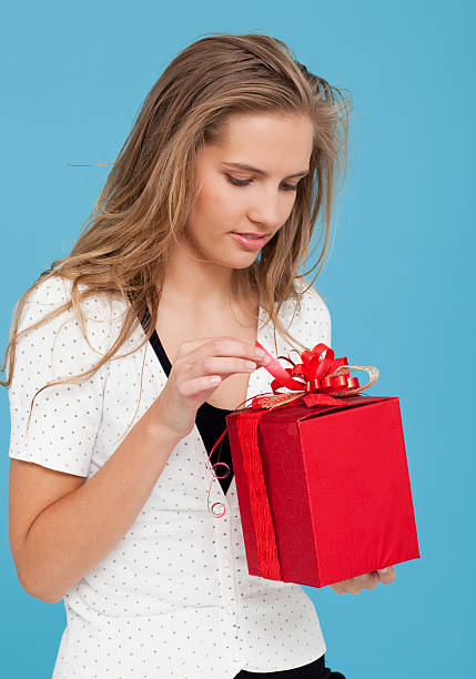 istock Woman Unwrapping Xmas Gift 176147421