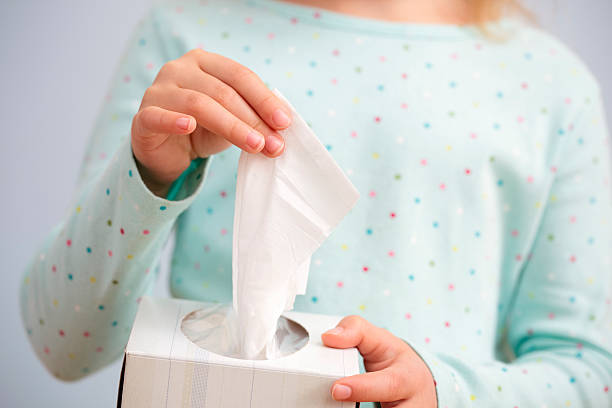 Pulling tissues out of a holder stock photo