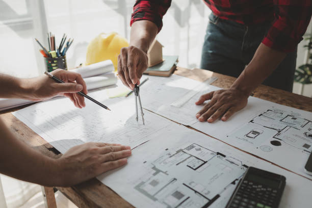 istock engineer is in planning meeting with architect about building a house,  Draw structural of buildings at the meeting and discuss together,  Design blueprints for use in structural work, architect idea. 1761488396