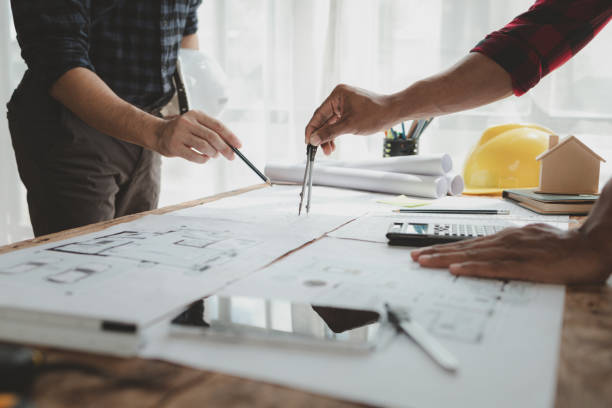 istock engineer is in planning meeting with architect about building a house,  Draw structural of buildings at the meeting and discuss together,  Design blueprints for use in structural work, architect idea. 1761488398