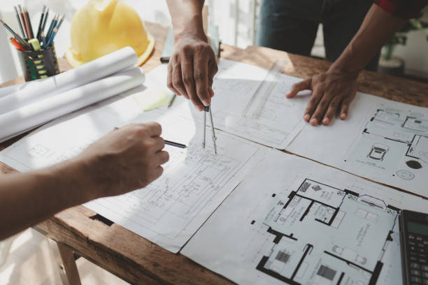 istock engineer is in planning meeting with architect about building a house,  Draw structural of buildings at the meeting and discuss together,  Design blueprints for use in structural work, architect idea. 1761488399