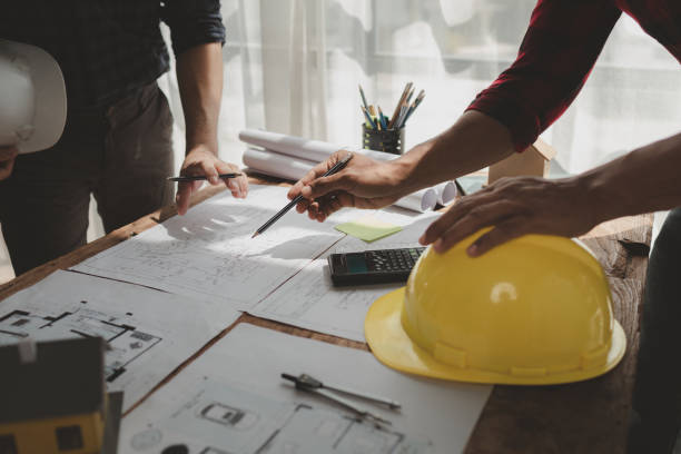 istock engineer is in planning meeting with architect about building a house,  Draw structural of buildings at the meeting and discuss together,  Design blueprints for use in structural work, architect idea. 1761488931