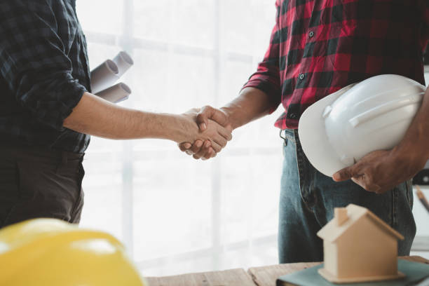 istock Architects and engineers agree on blueprints together, An agreement is being made regarding the structure of the building, The plan has been approved by the architect, architect idea. 1761489449