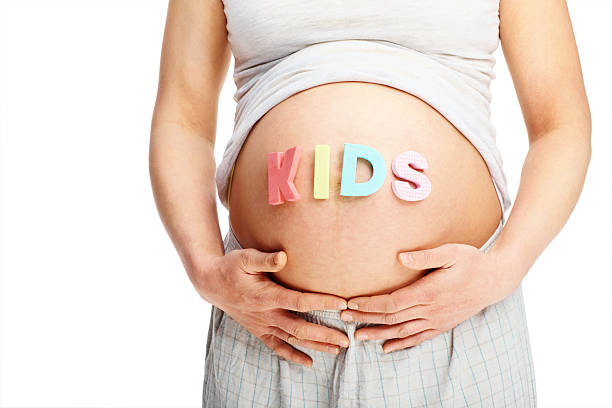 istock Mid section of pregnant female exposing her belly 176149630