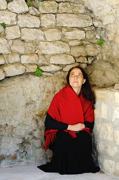 istock Poor woman looking up in stone corner 176150162