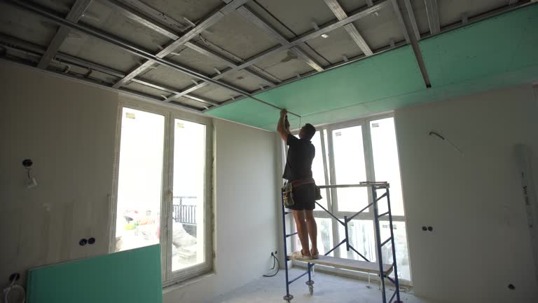 Construction worker ceiling work installation