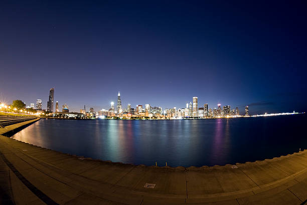 Wide View of the Chicago Skyline at Twilight A wide, fisheye view of the Chicago Skyline at dusk, as seen from across Lake Michigan.   aon center chicago photos stock pictures, royalty-free photos & images