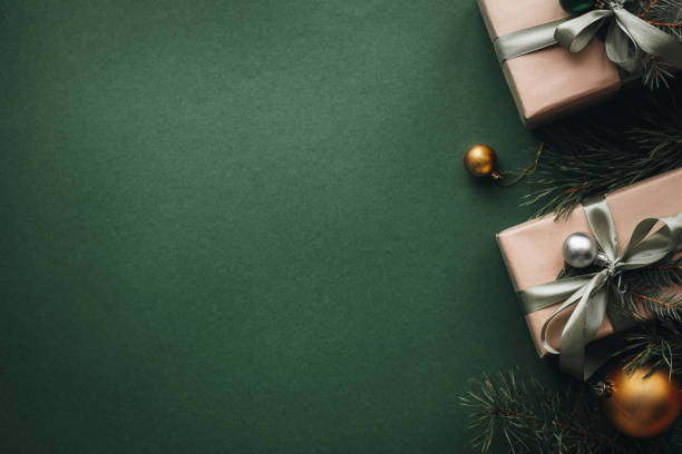 istock Banner with gift boxes, Christmas tree and toys on a dark green background. 1761530895