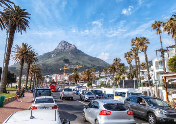 Cape Town, South Africa - 05 Oktober 2023: Traffic and beach, Camps Bay attracts the rich and famous for its luxury lifestyle options and belongs to the Atlantic Seaboard.