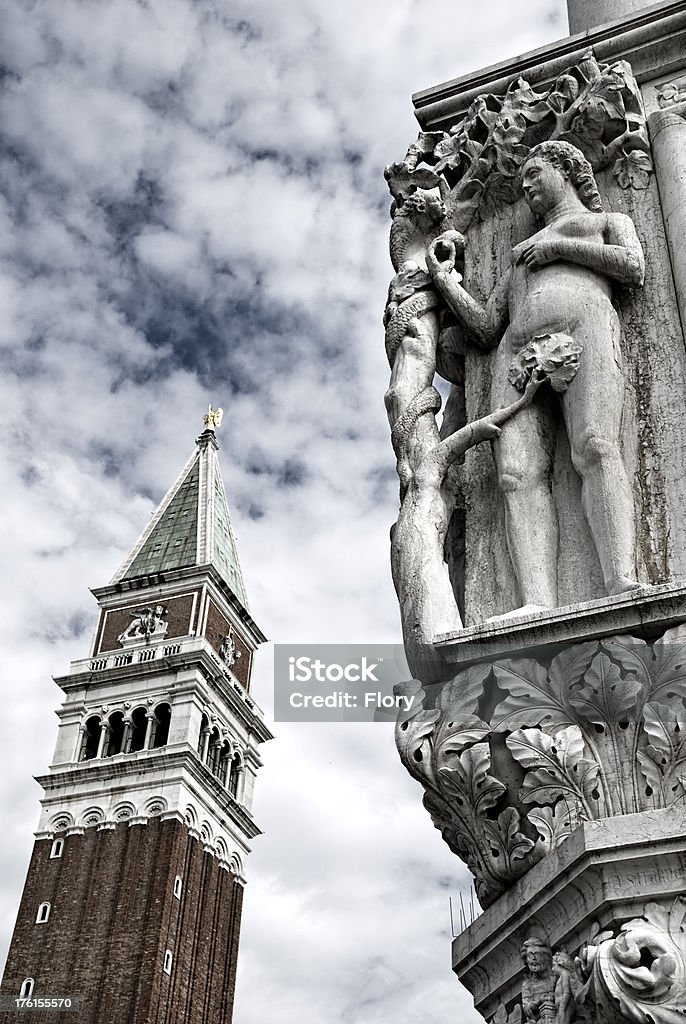 Campanile and Doge Palace in Venice sculpture of a column at the Doge Palace in St Mark's Square. Venice Italy. Architectural Column Stock Photo
