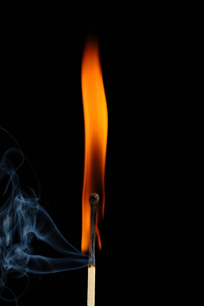 istock Burning match with smoke on black background. 1761559432