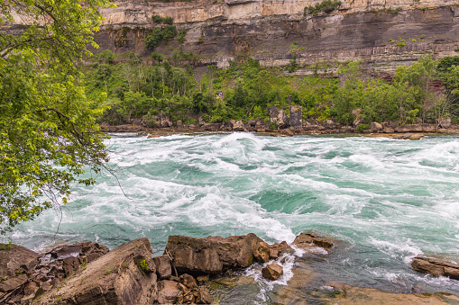 Scenic view with rocky foreground of the rapids of the Niagara river, Niagara Falls, Canada