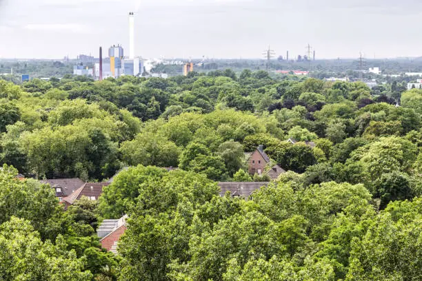 high angle view of the park landscape of the Kaisergarten with view to the industry in Oberhausen, Germany