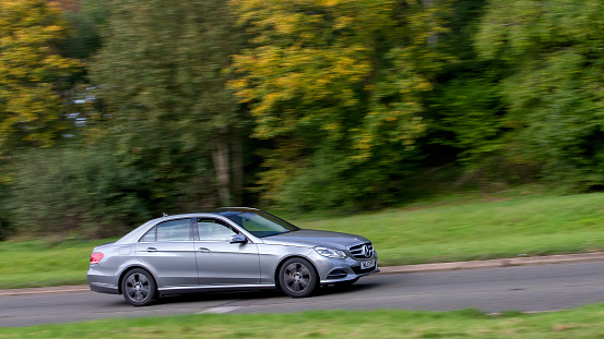 Milton Keynes,UK - Oct 28th 2023: 2013 silver diesel engine Mercedes-benz E car driving on an English road