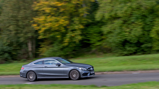 Milton Keynes,UK - Oct 28th 2023: 2018 grey diesel engine Mercedes Benz C 250 AMG line  car driving on an English road