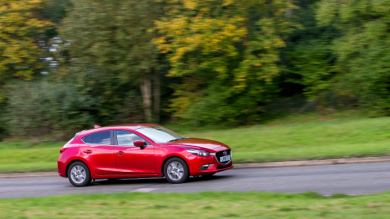 Milton Keynes,UK - Oct 28th 2023: 2018 red Mazda 3 car driving on an English road