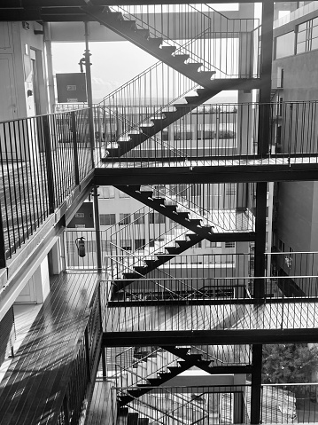 Old-fashioned spiral staircase. Black and white and low angle shot.