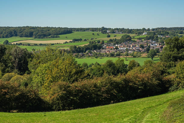 istock Village in lush hilly countryside under a blue sky during summer. 1761610992