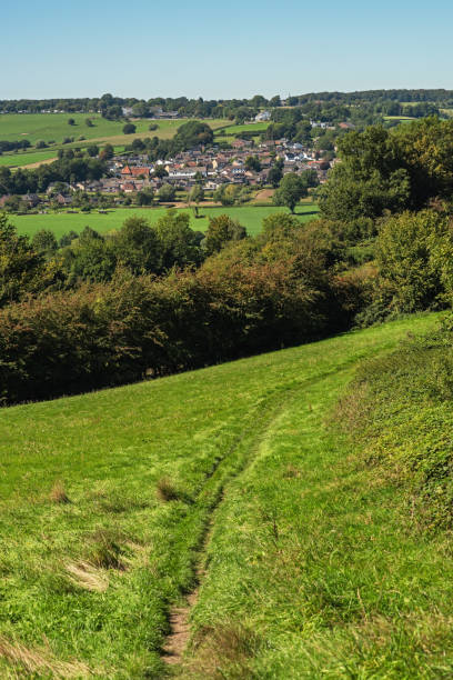 istock Village in lush hilly countryside under a blue sky during summer. 1761611036