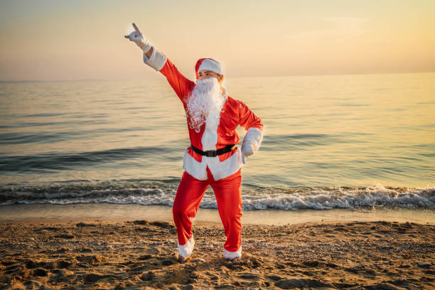 istock Happy Santa Claus dancing on the beach 1761614082