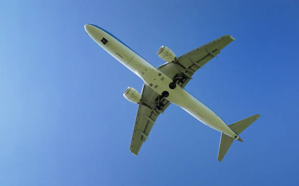 istock Passenger Plane Landing Overhead with Blue Sky in the Background 1761633863