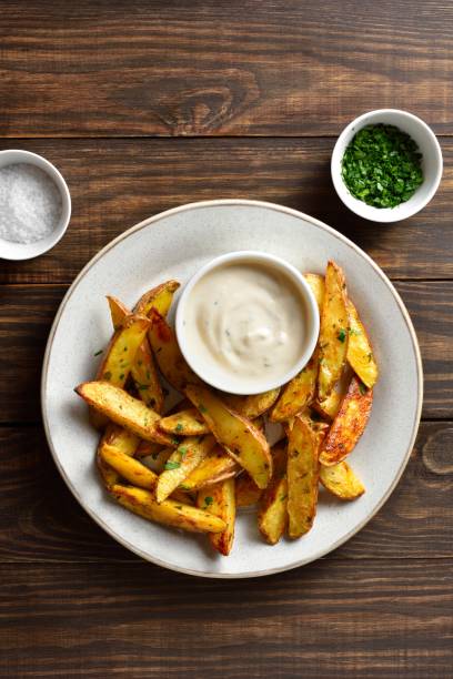 istock Baked potato wedges with sauce 1761636002