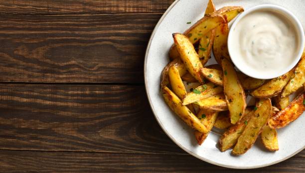 istock Baked potato wedges with sauce 1761636007