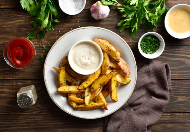 istock Baked potato wedges with sauce 1761636021