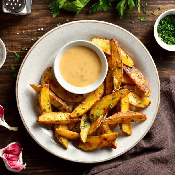 istock Baked potato wedges with sauce 1761636042