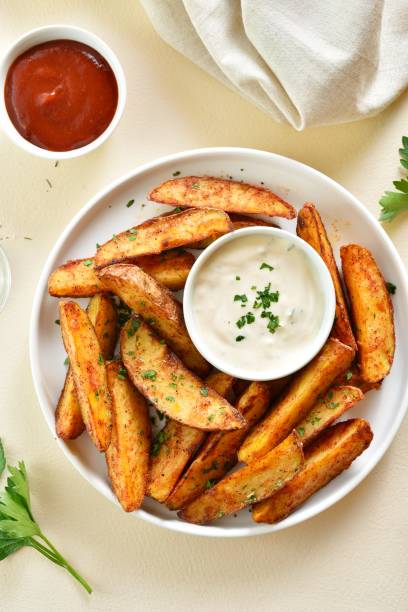 istock Oven baked potato wedges with sauce 1761636048