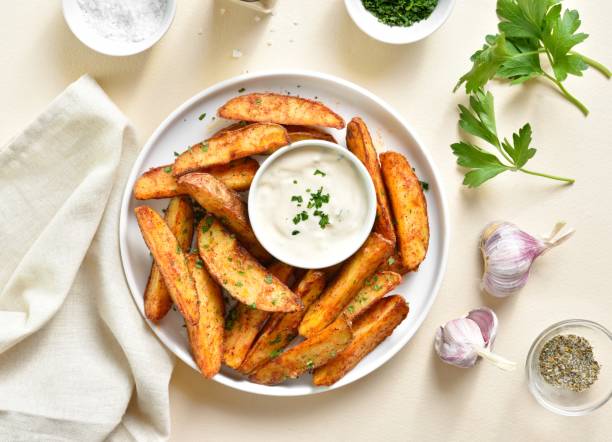 istock Baked potato wedges with sauce 1761636115